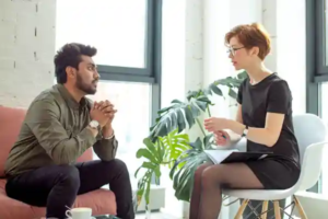 Two people in a counseling session discussing a personalized quit plan in a bright, welcoming room.