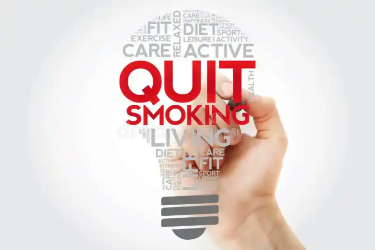 Hand writing “QUIT SMOKING” inside a health-themed light bulb made of wellness-related words.